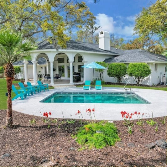 Backyard pool and covered patio at Shore Rush Cottage on St. Simons Island